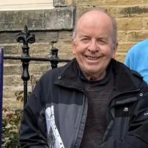 An older male posing for a photo