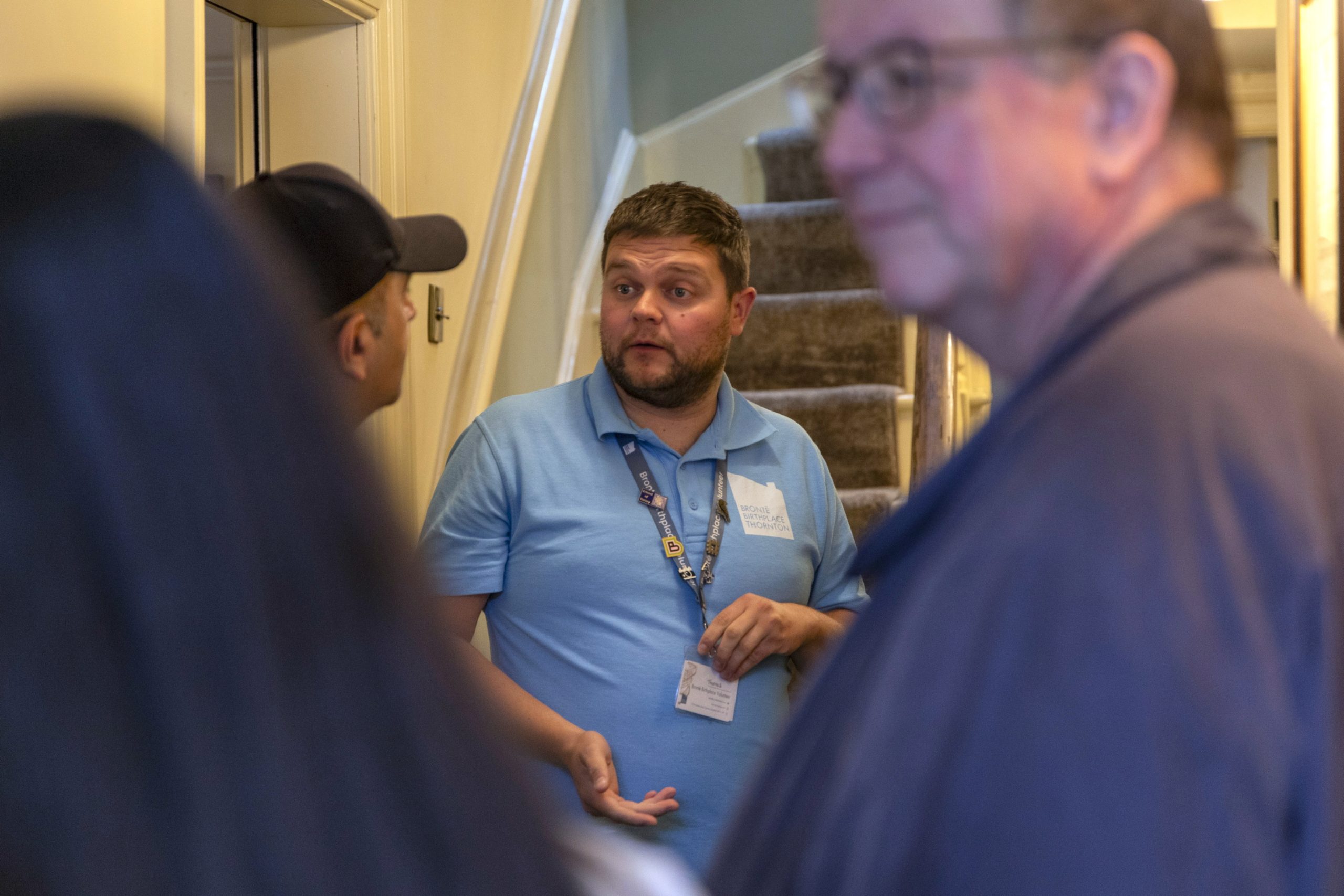 A volunteer giving a tour for other people