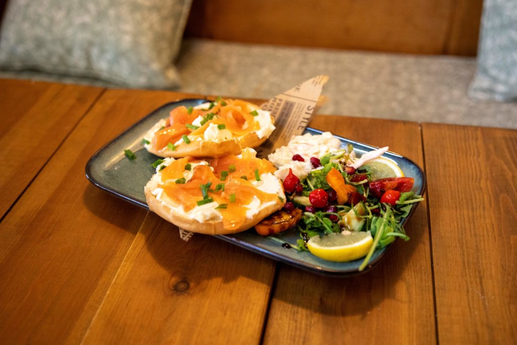 Salmon bagel and salad on a plate