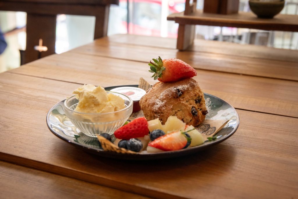 Scone and fruit on plate